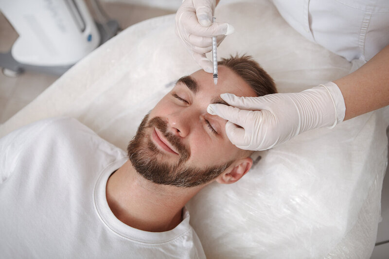 young man getting dermal filler treatment