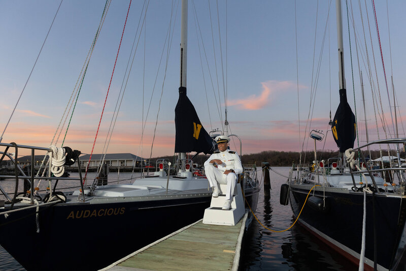 US Navy Officer sitting on dock at twighlight