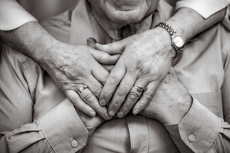 Black and wite photo of elderly couple holding hands