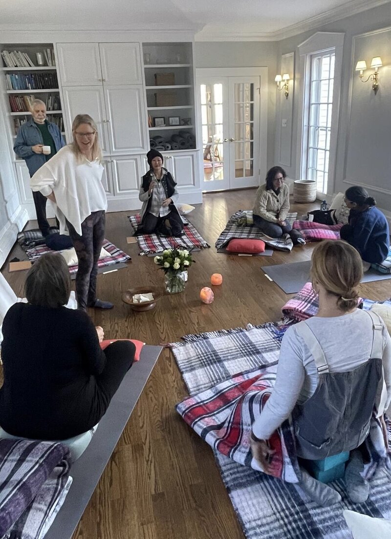 Recent Photo of a Supported Awakening weekend non-duality exploration immersion showing men and women chatting and drinking tea during a break.