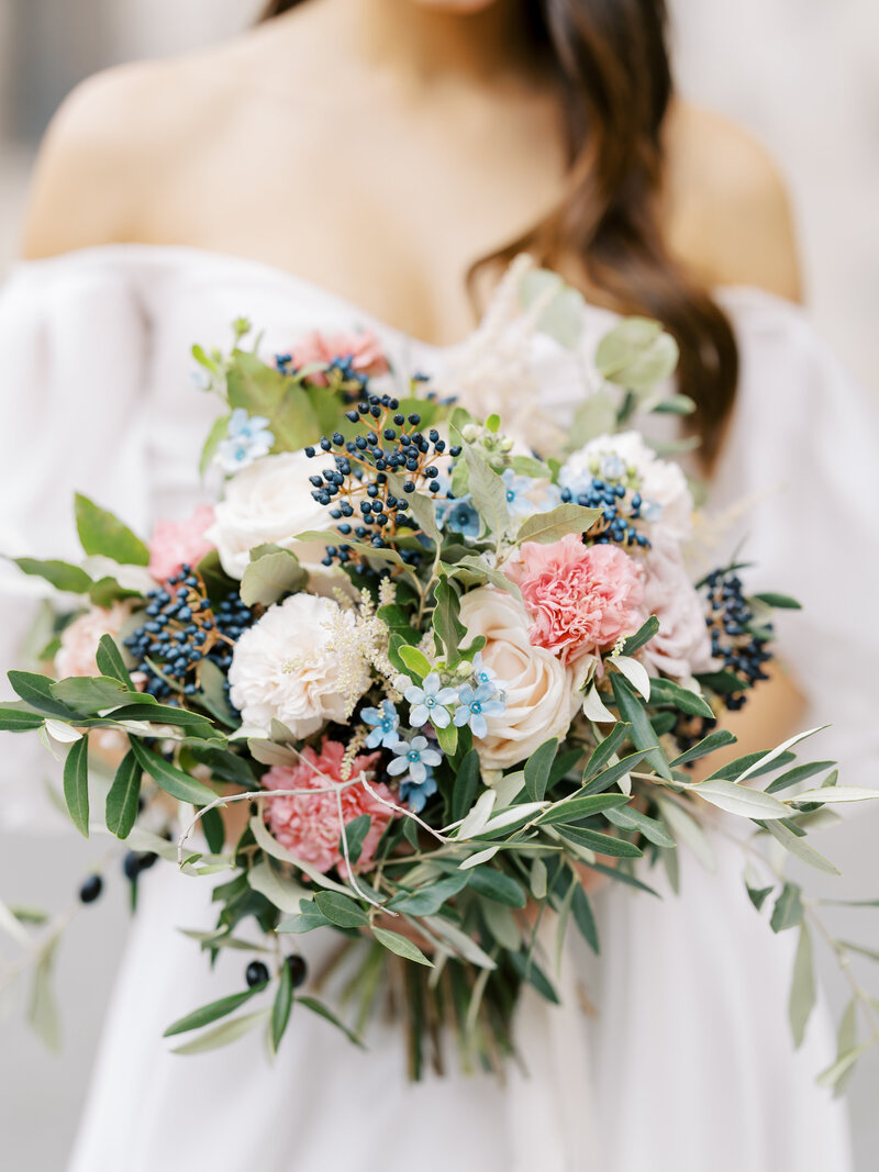 closeup of pink, cream, and blue bridal bouquet in Siena, Italy