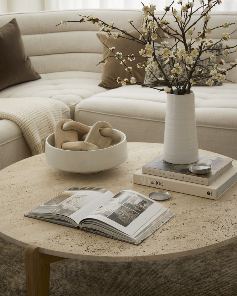 styled white bookshelf with vases books wallpaper boxes and accessories