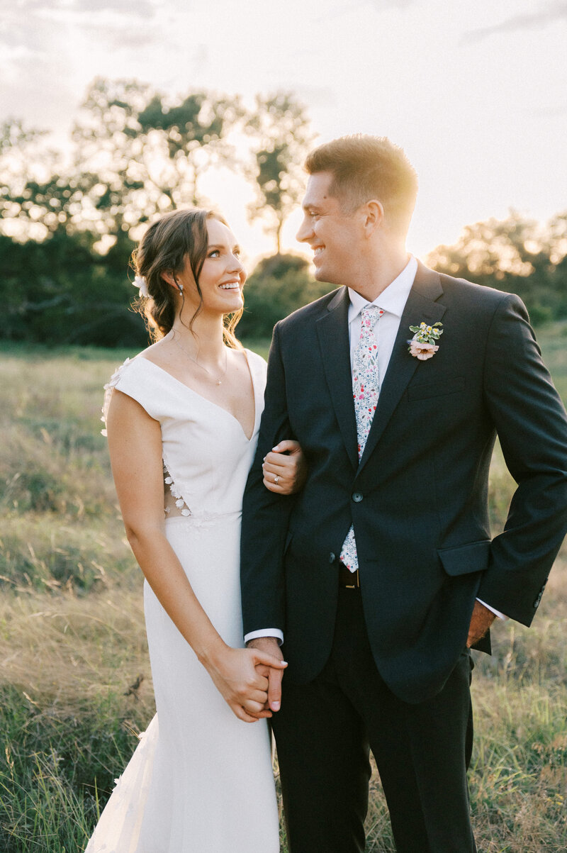 sunset golden hour bride and groom wedding photos in field at ladybird johnson wildflower center by austin wedding photographer