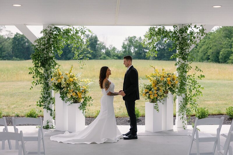 Bride and Groom during ceremony at Micro Wedding Venue Hazelwood overlooking fields