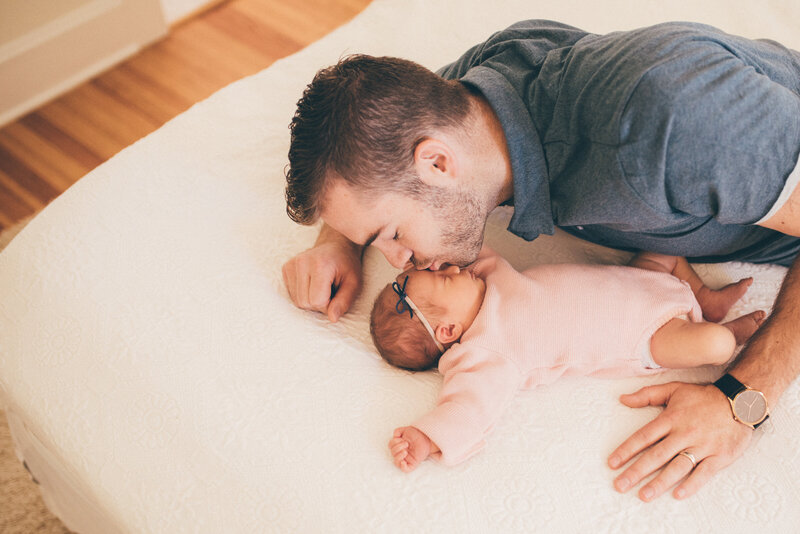 DAD KISSING NEWBORN