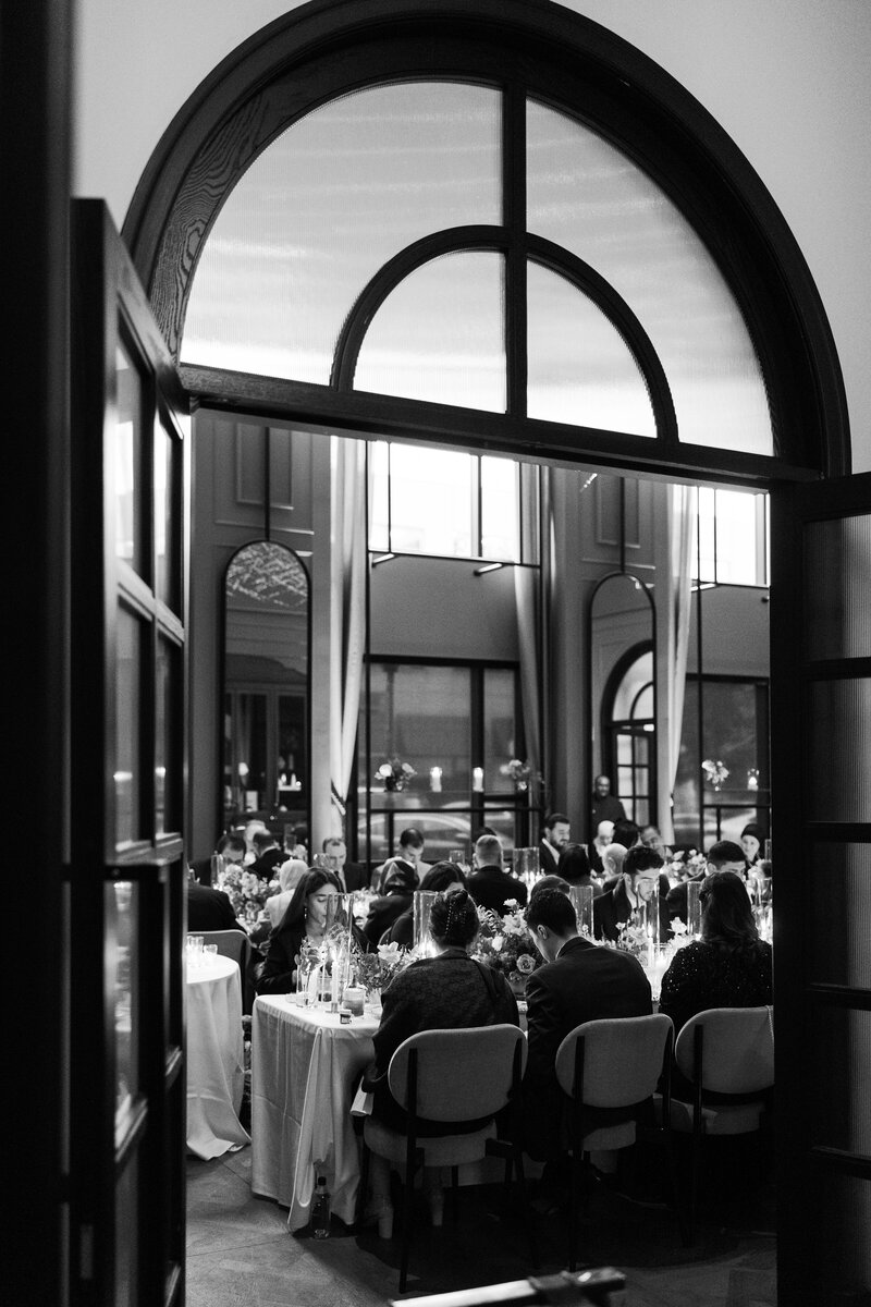 Guests enjoying dinner at a small wedding reception.