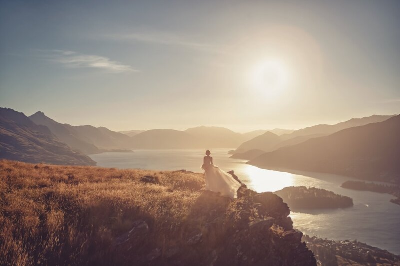A golden light outdoor photoshoot of a woman wearing a couture dress.