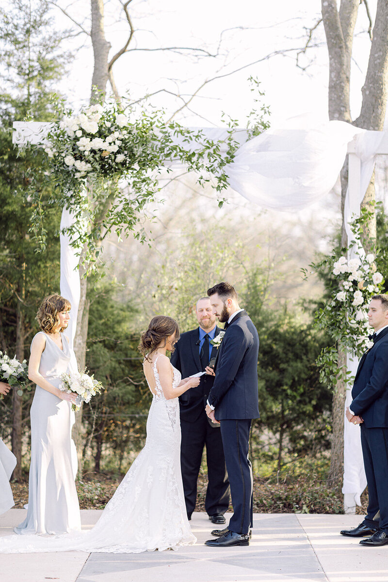 Bride and groom reading vows during their wedding ceremony