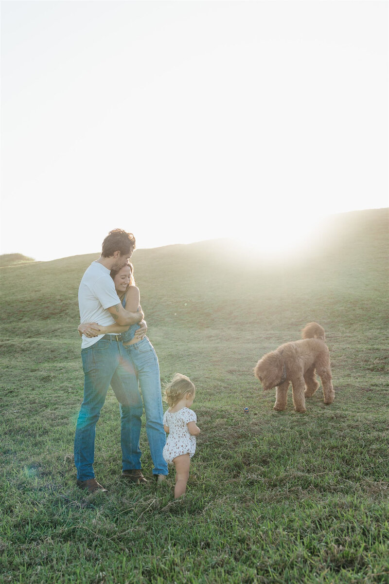 Parents and children embracing during a styled family photo shoot in Maui, golden hour editorial session.