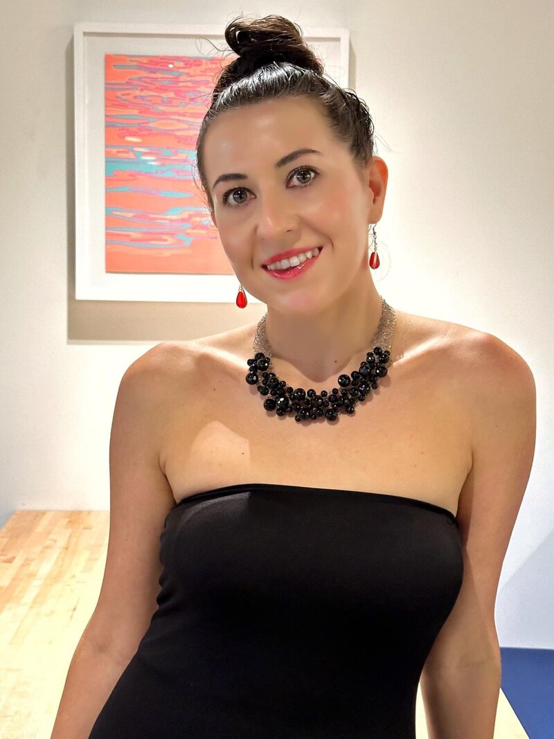 Ana-Maria Georgieva in a black dress on a red chair