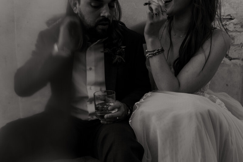 couple drinking in candid wedding reception photo 