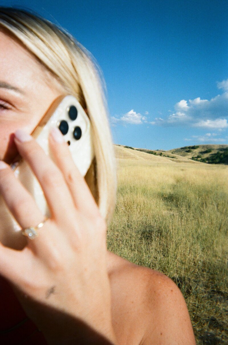 woman sitting on chair looking at cellphone