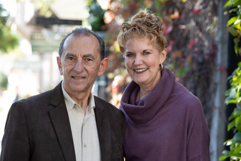 smiling older man and woman married business partners wearing professional attire