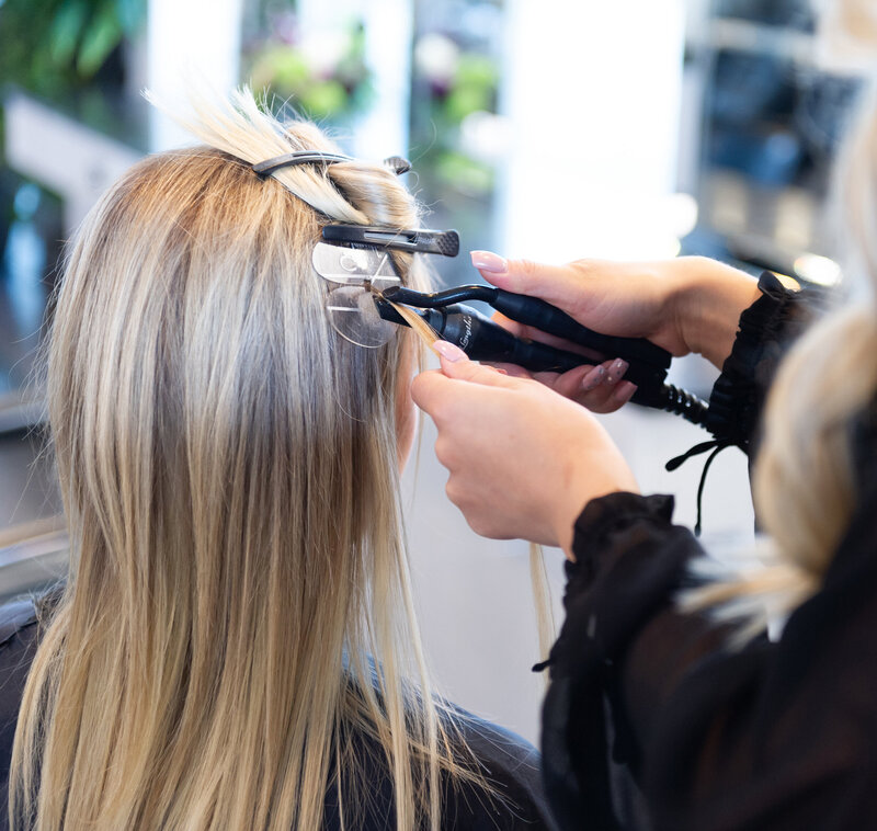 Stylist adding extensions