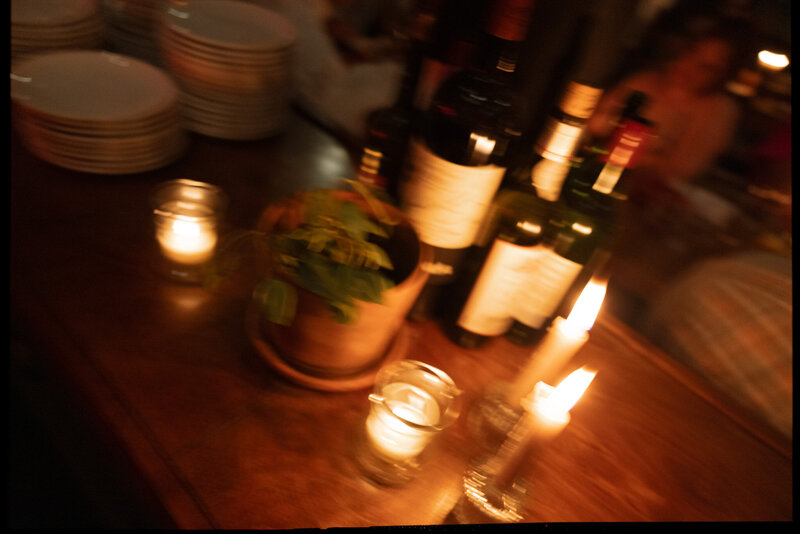 Blurry candlelit photo featuring wine at the Peninsula located in East Nashville. 