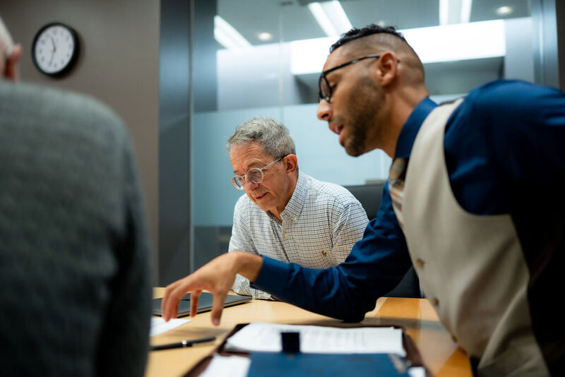 Divorce and family law attorney walking and talking with two clients
