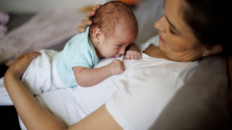 mother holding newborn baby during postpartum