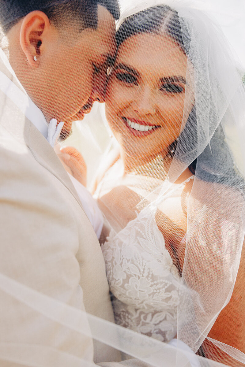 Western Montana bride and groom embracing under wedding veil