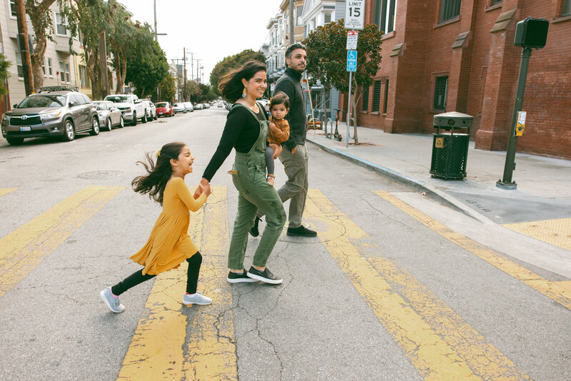 family of four crossing the street in the mission district of san francisco
