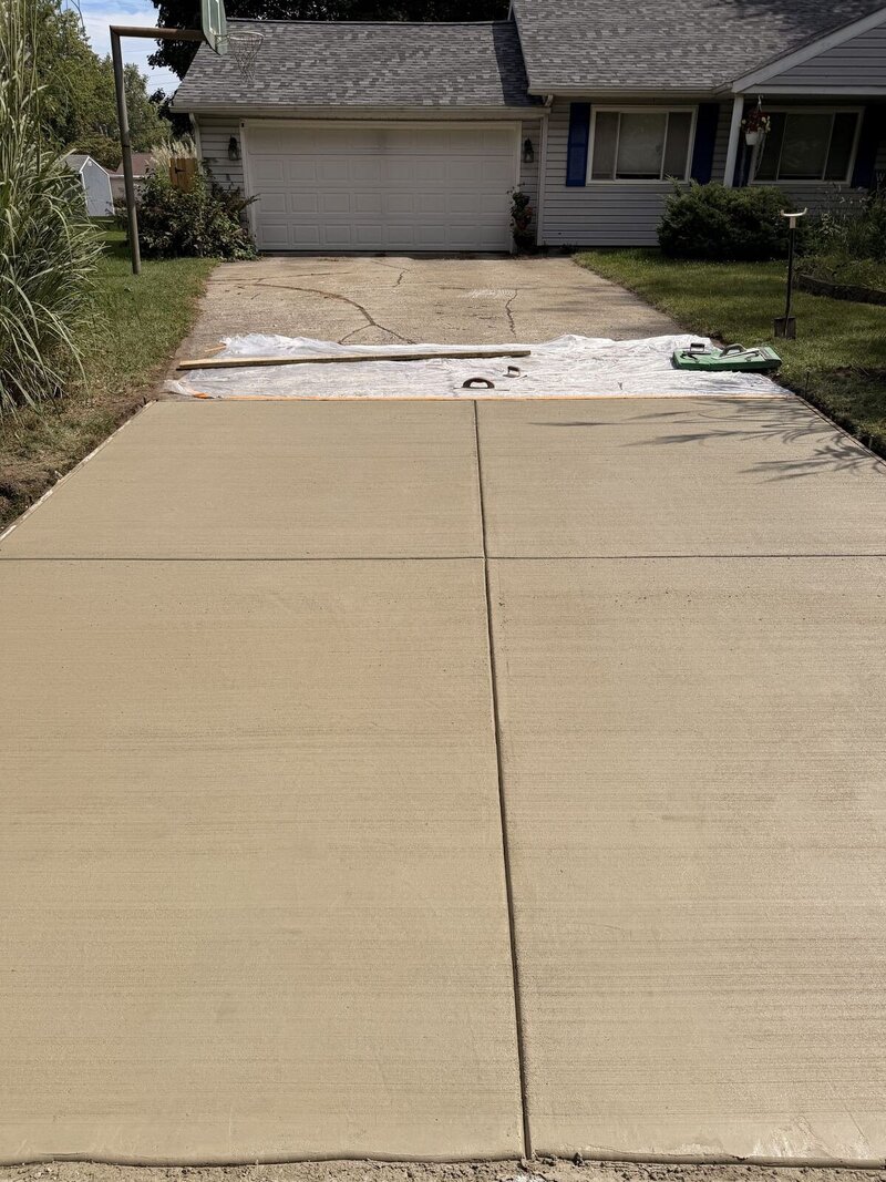 After: new concrete driveway section with control joints in Middlebury, IN