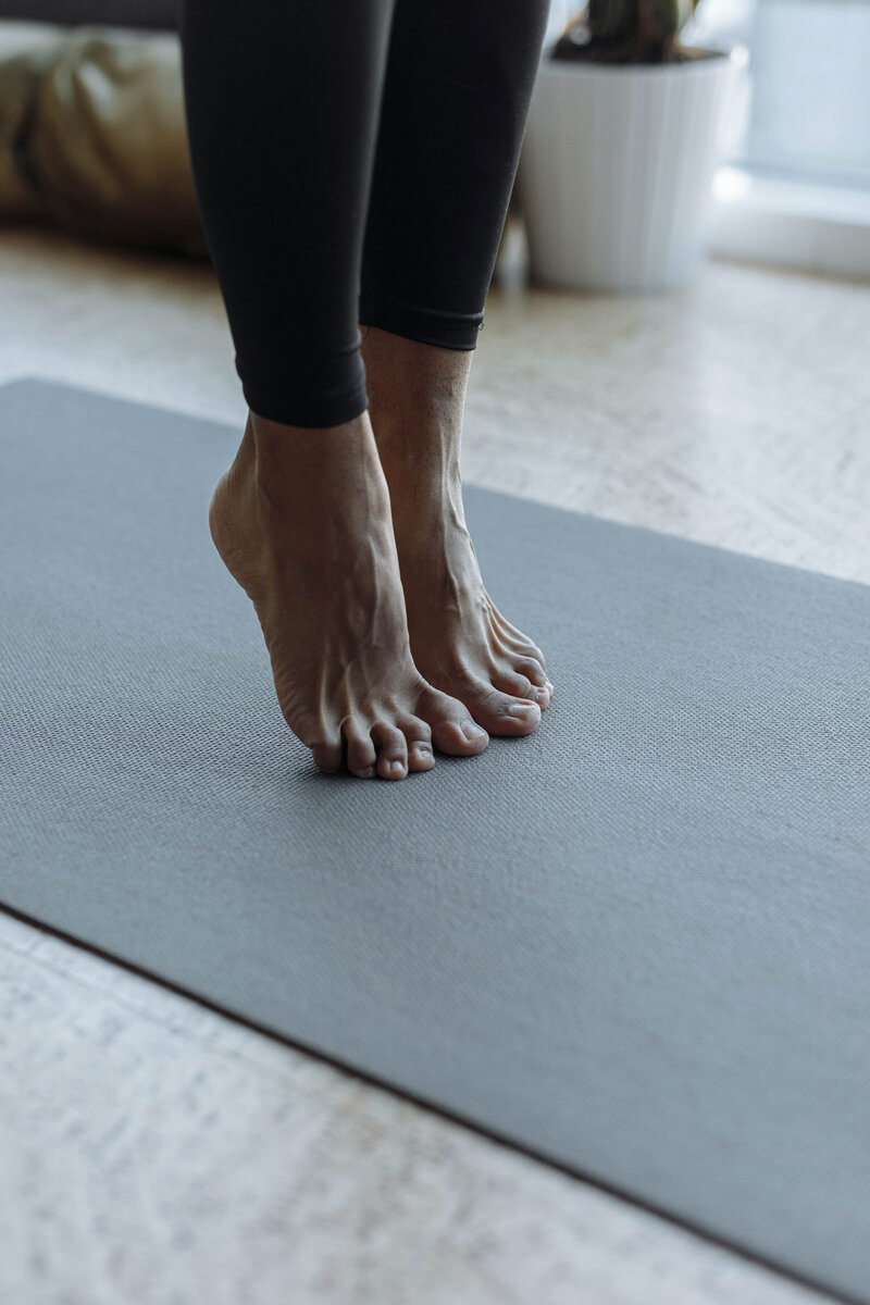 Woman in yoga pants on yoga mat 