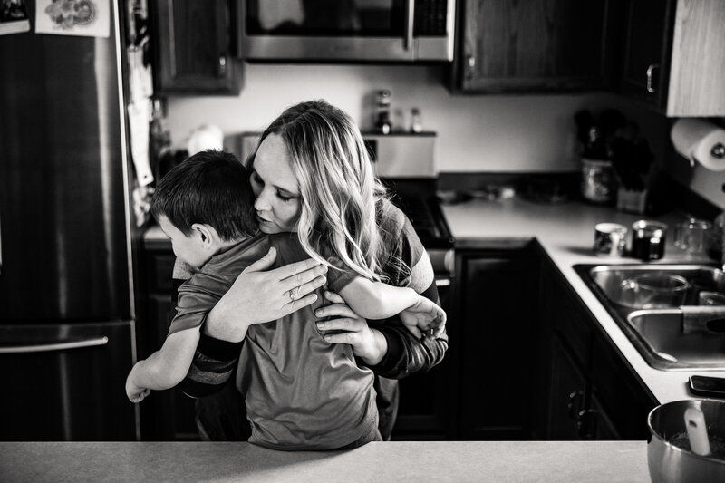 mom-hugging-child-kitchen