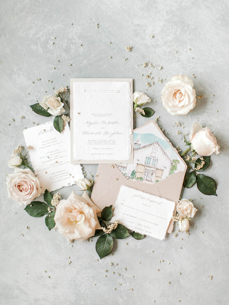 wedding invitations with beige envelopes and light pink roses