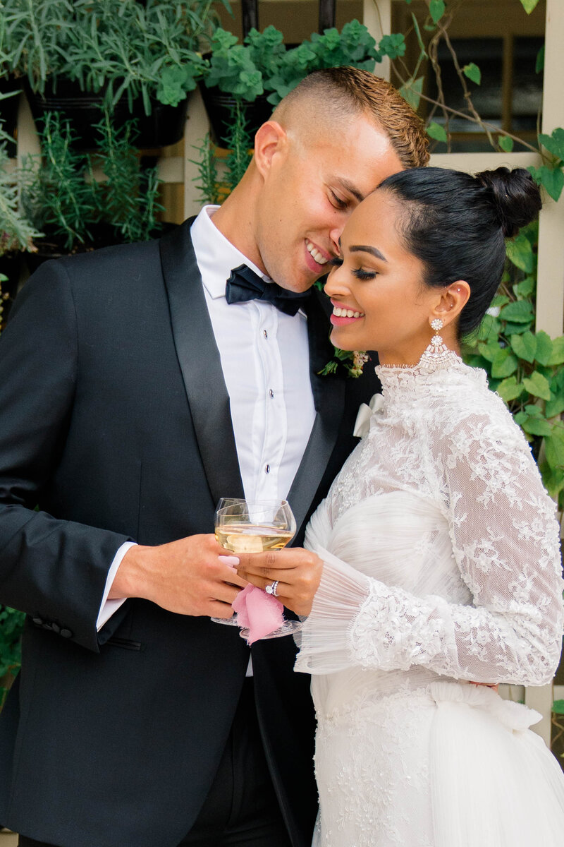 Wedding Photographer Newport RI | Rhode Island Caprio Captured Photography | Bride And Groom Holding a Champagne Glass While Smiling