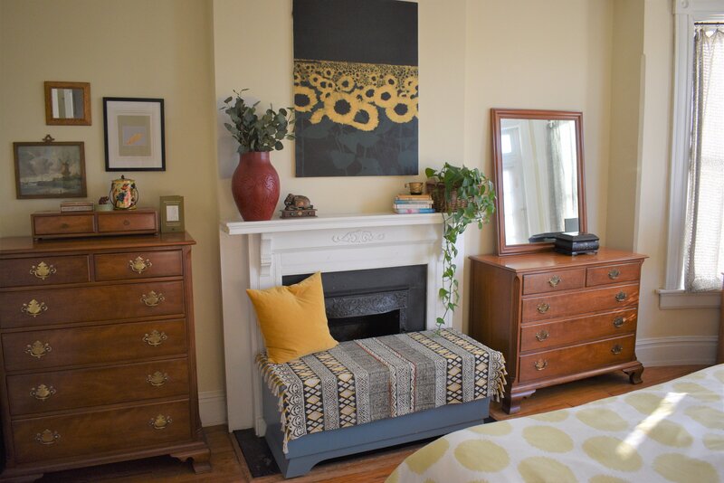Dressers and bench by fireplace