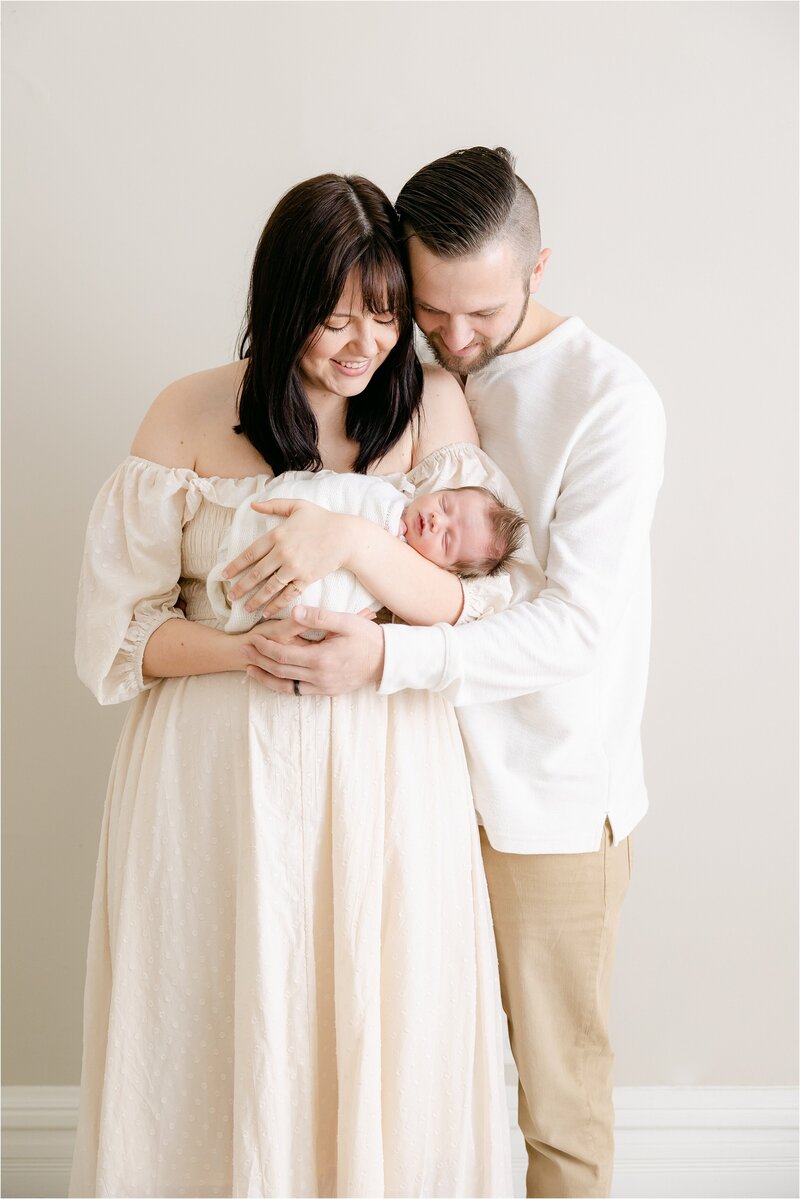 young family admiring newborn baby at an indianapolis newborn photography session