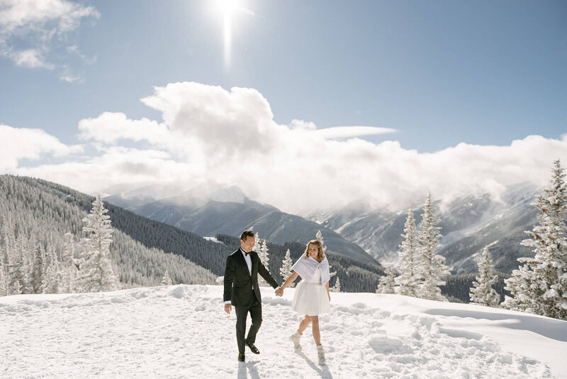 bride and groom on snowy mountaintop