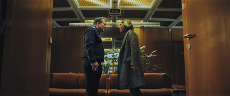 A close-up of the lead character with dramatic lighting and subtle expression.