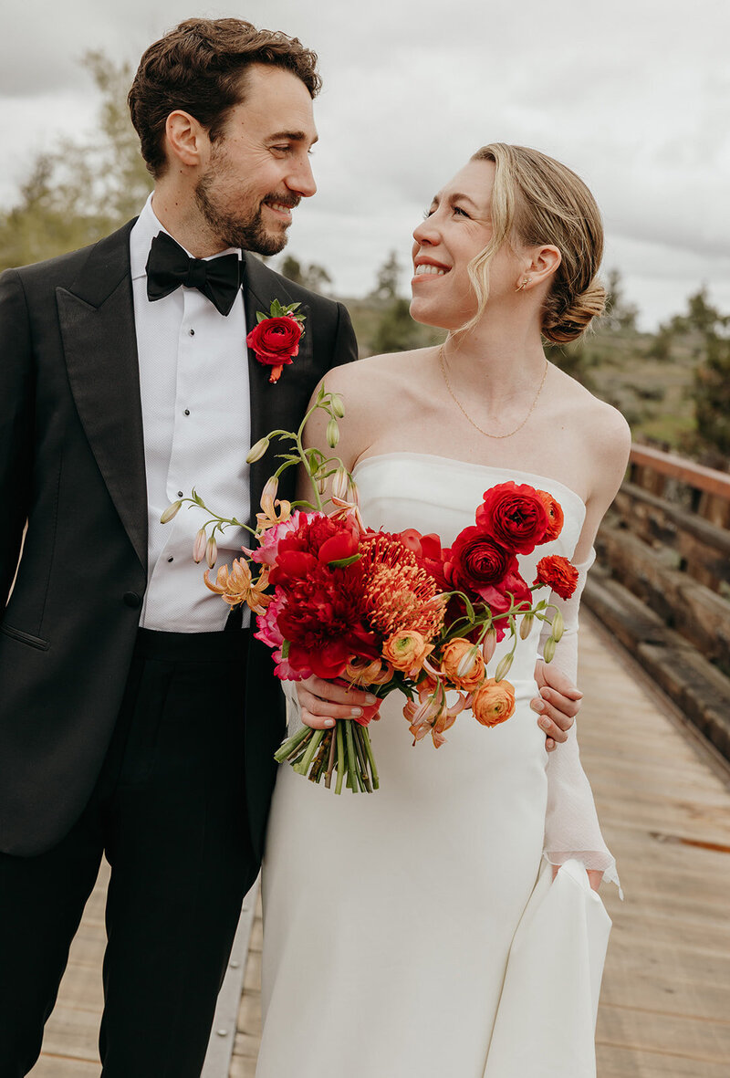 Spring wedding bouquet with protea, lilies, and garden roses