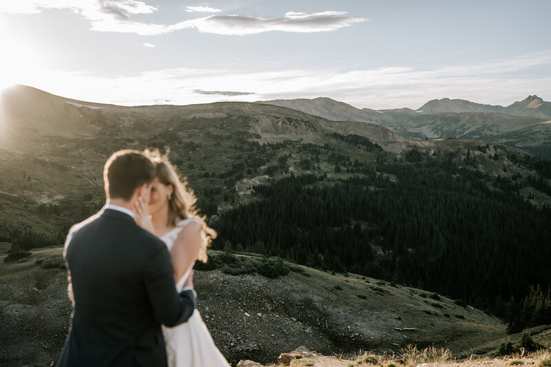 rocky mountain national park elopement at sunrise, bride and groom embracing