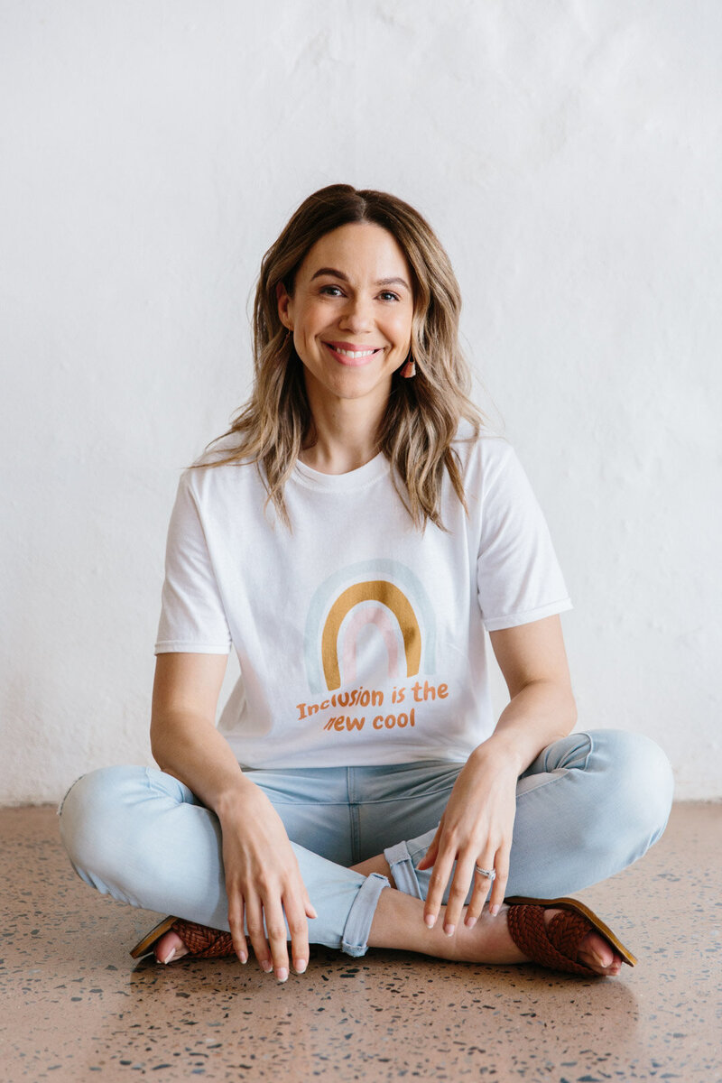 Woman sitting and smiling at Camera