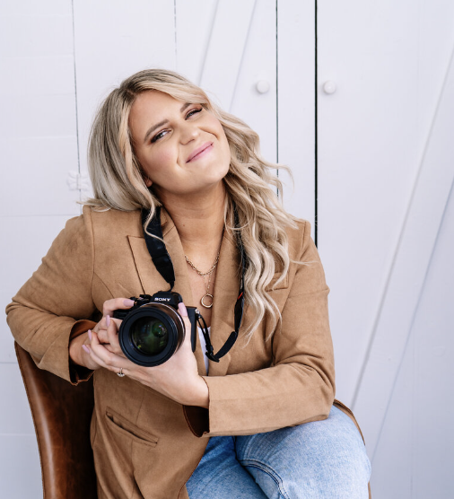 Idaho based wedding photographer smiling at the camera  while wearing a brown wide rimmed hat