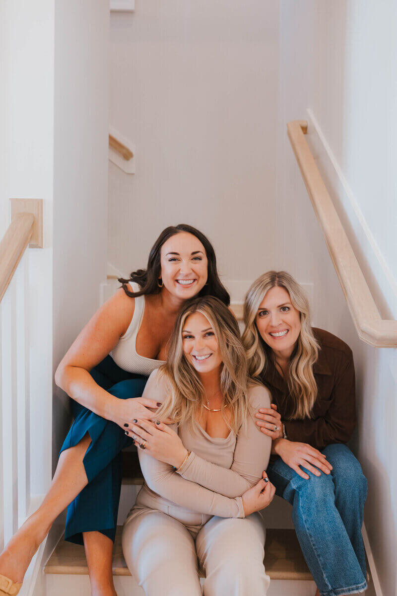 Raleigh Real estate agency, Jacie and Co, sitting on stairs.