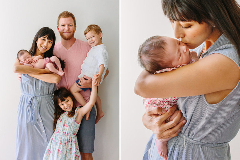 A family holds their newborn baby during their newborn photo session
