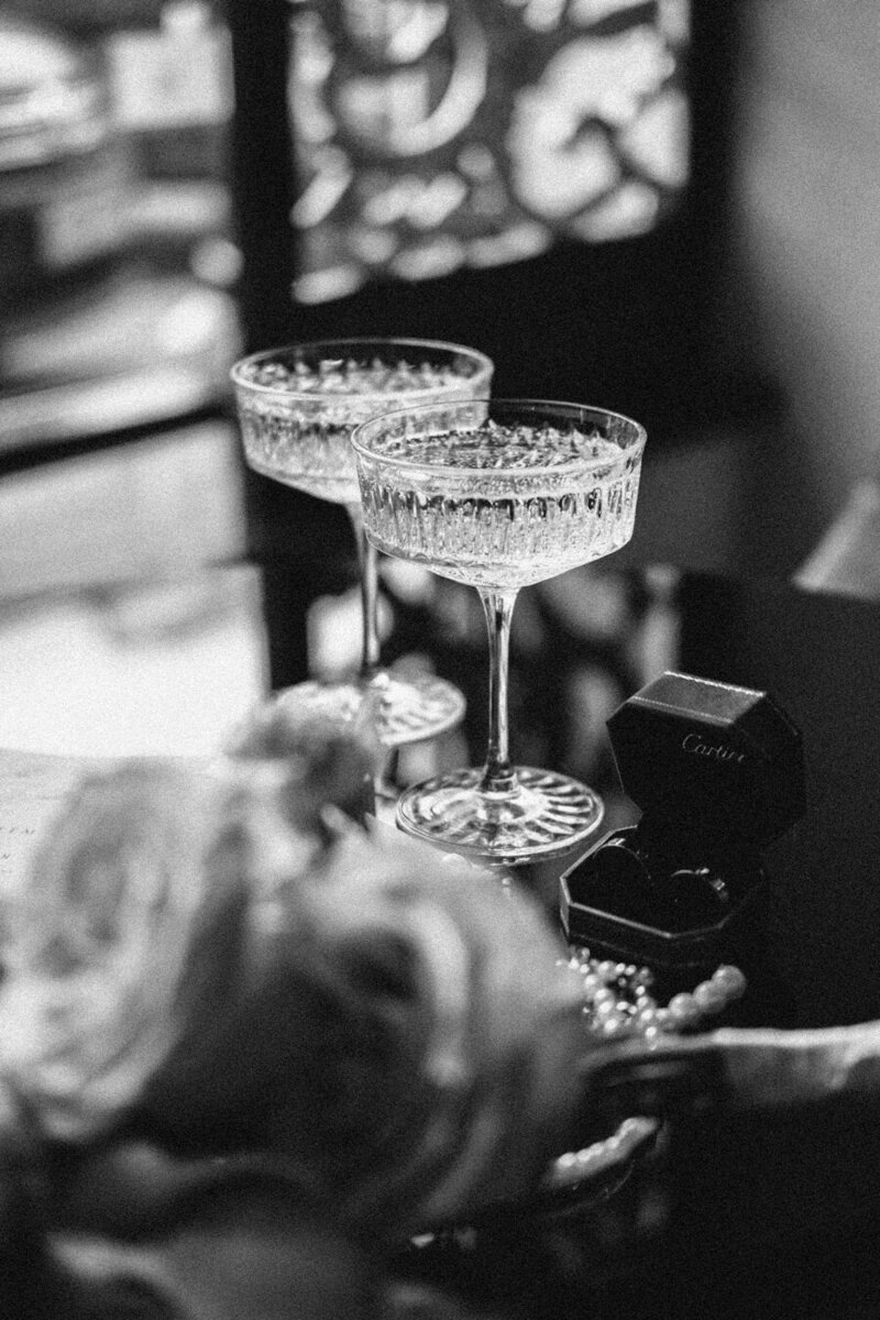 Black and white photo of champagne coupe glasses.