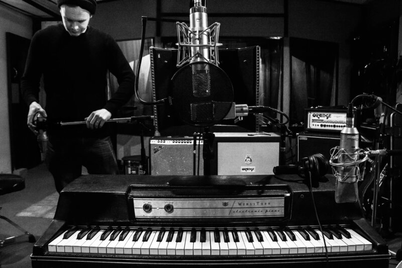 Producer guitarist engineer Will Schollar working in music studio