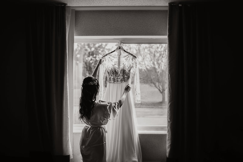 bride in window with dress silhouette
