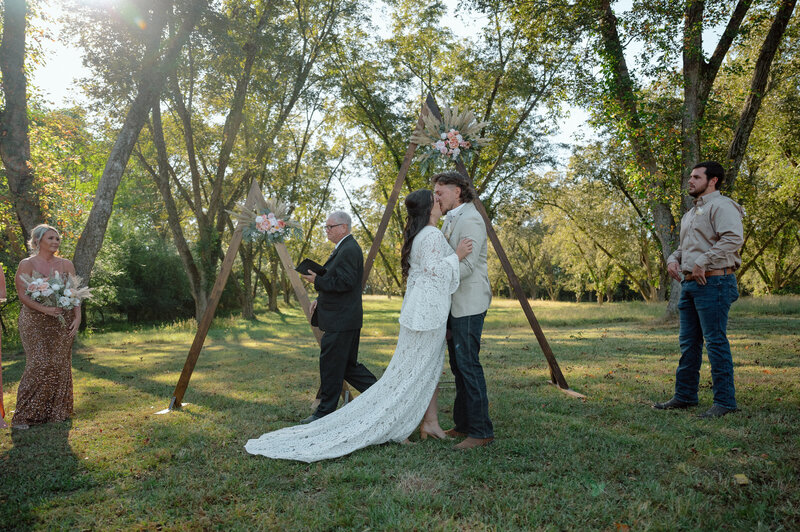 bride and groom, first kiss after their Georgia wedding ceremony