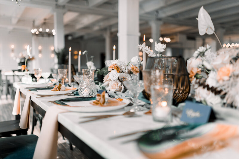 Woman adjusts the details on a wedding reception table