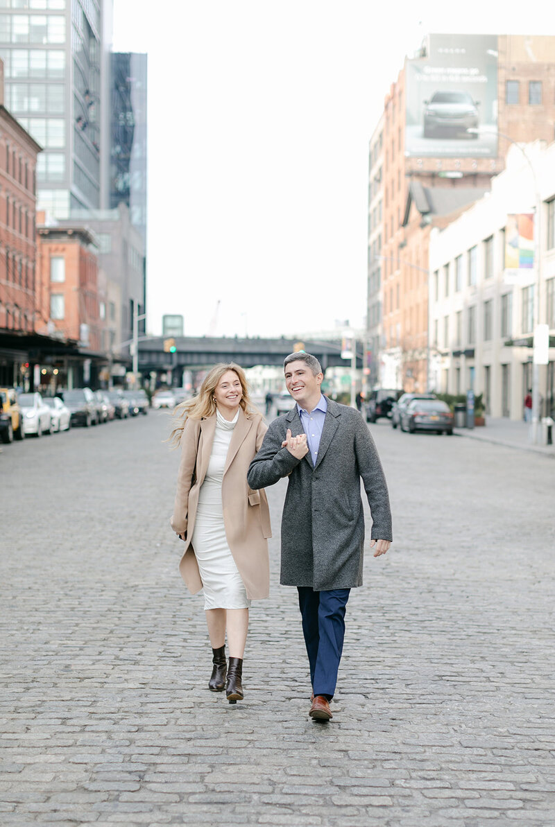 couple-walking-cobblestone-street-manhattan