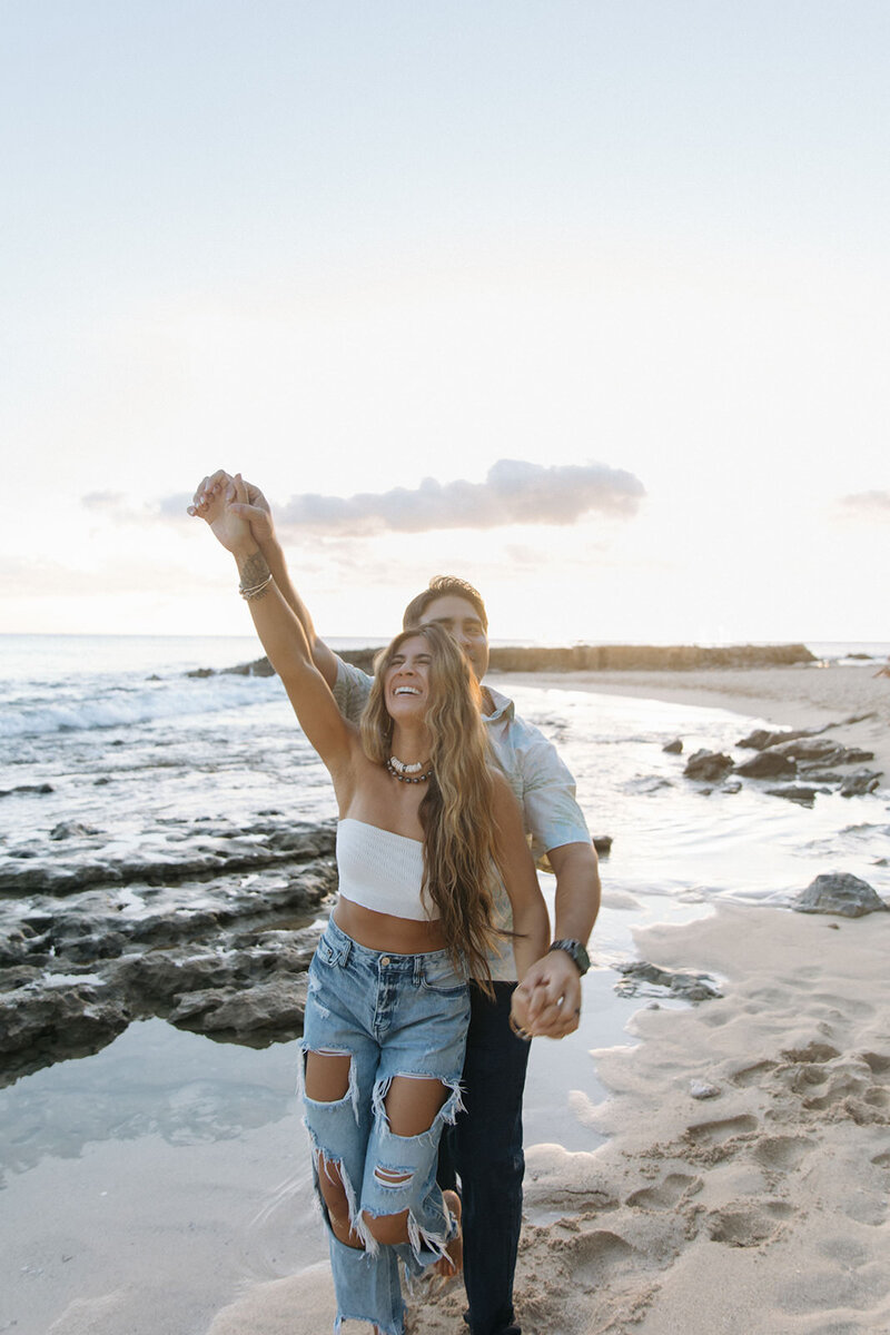 couple laughing on the beach together