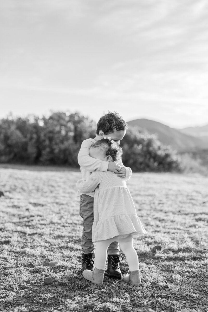 Two children hugging each other tightly.  Taken by Los Angeles wedding photographer Rachel Paige Photography