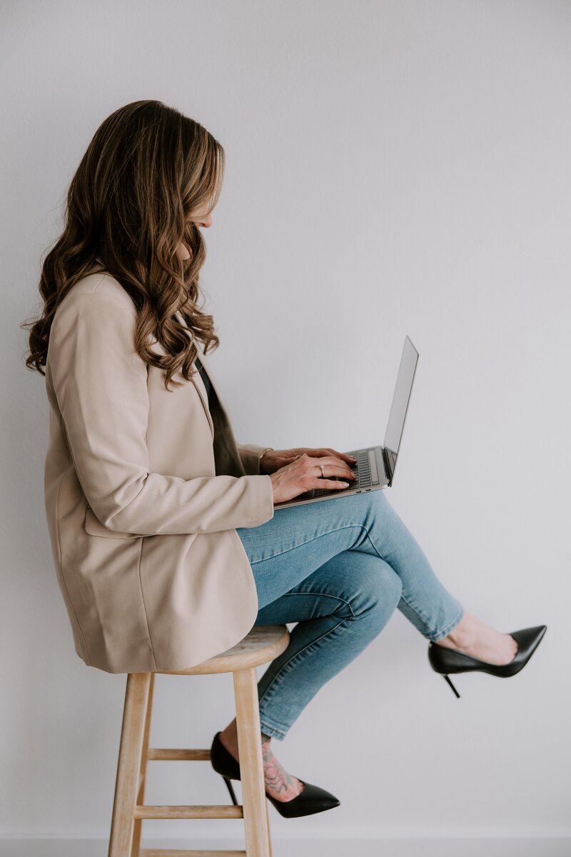 Website copywriter Erika Fitzgerald using a laptop to write copy for websites