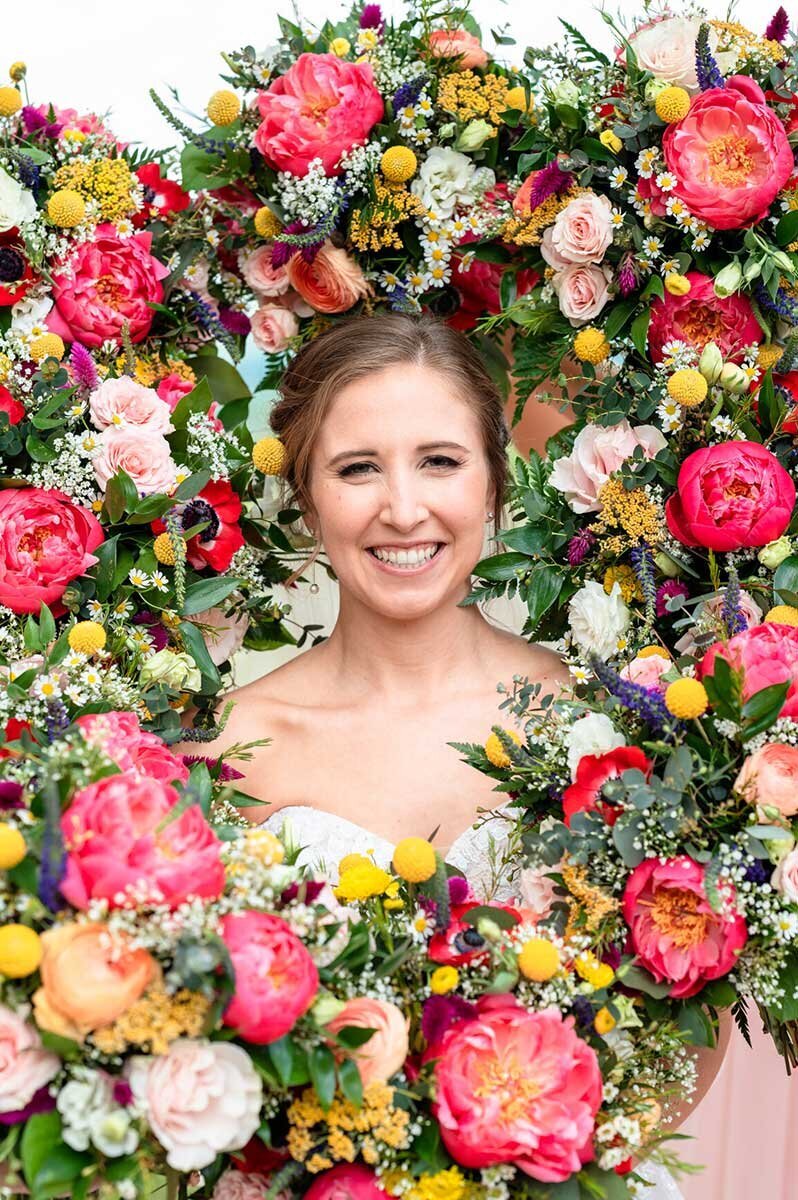 Jacksonville bride poses with spring pink bouquets
