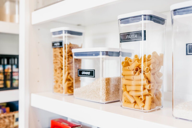 A kitchen pantry featuring contained pasta products