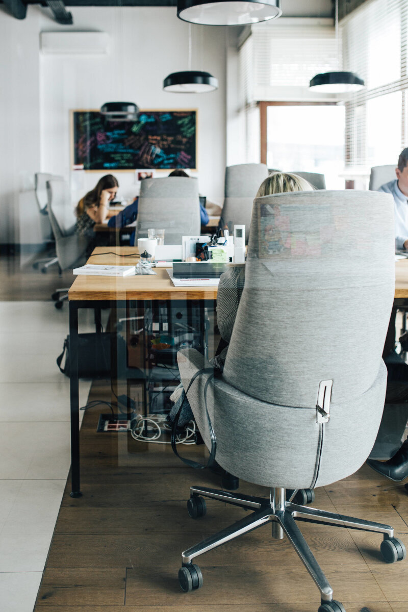 Office chairs and desks in a coworking space.